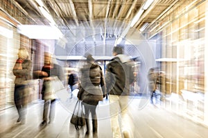 People walking in shopping centre, zoom effect, motion