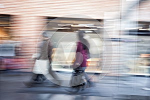 People walking in shopping centre, zoom effect, motion