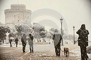 People walking in the snow in the center of the city on a winter day