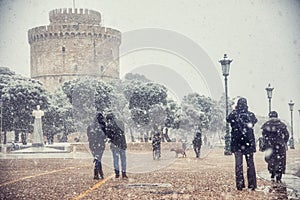 People walking in the snow in the center of the city on a winter day