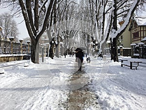 People walking on a snowy day in the city back to camera