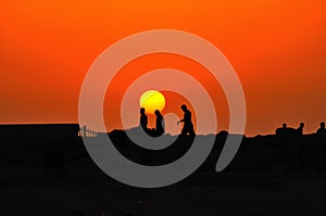 People walking on sunset