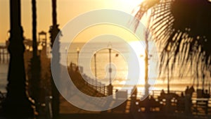 People walking, wooden pier in California USA. Oceanside waterfront vacations tourist resort.