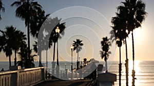 People walking, wooden pier in California USA. Oceanside waterfront vacations tourist resort.