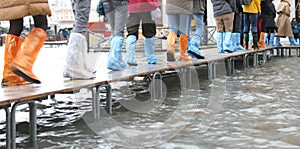 people walks on the footbridge in Venice in Italy with colored p