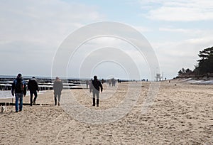 People wandering on the Baltic Sea beach