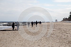 People wandering on the Baltic Sea beach