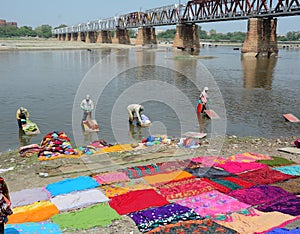People washing clothes on the river