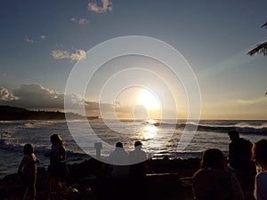 People watch Beautiful Sunset over the ocean