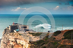 People watching big waves in Nazare, Portugal