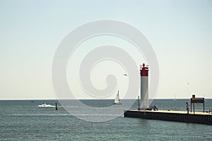People watching boats at lighthouse