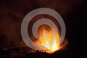 People watching the eruption of a volcano.