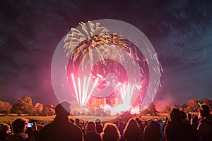 People watching Fireworks display at bonfire 4th of November celebration, Kenilworth Castle, united kingdom.