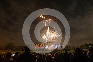 People watching Fireworks display at bonfire 4th of November celebration, Kenilworth Castle, united kingdom.