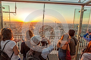People watching panorama of Paris with Eiffel Tower against colorful sunset in Paris, France