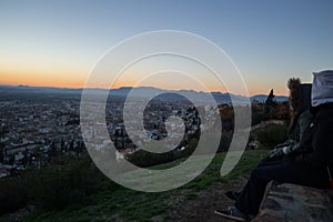 People Watching Sunset at Mirador del Barranco del Abogado Lookout in Granada, Spain photo