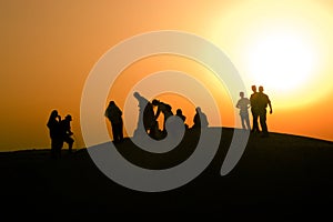 People watching the sunset in the Sahara desert