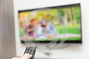 People watching tv hand with remote control