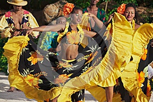 People wearing colorful dresses perform traditional creole Sega dance at sunset in Ville Valio, Mauritius.