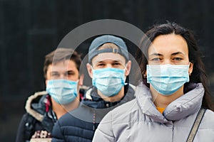 People wearing face masks outdoors. Coronavirus quarantine photo