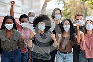 People wearing protective face mask protesting and showing fists
