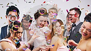 People, wedding and dance in studio with confetti for celebration, success and party at reception or formal event. Happy