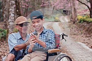 People on the wheelchair using smart phone