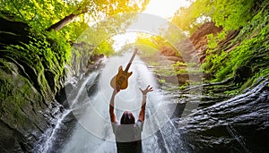 the people who throwing guitar into waterfall
