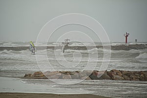People windsurfing on a stormy day