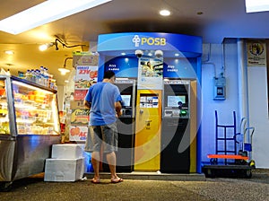 People withdraw money from ATM in Chinatown, Singapore