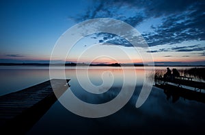 People on wooden dock at german lake