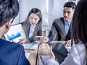 People at work: business team having a meeting with team training flipchart office