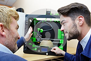 People working on 3d cutting paper machine