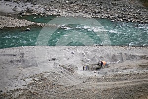 People working on the bank of a river in Nepal.