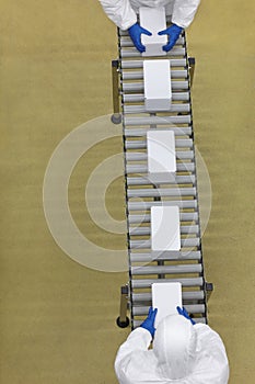 People working with boxes on packing line