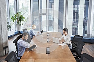 People working and communicating together in creative office