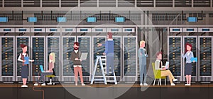 People Working In Data Center Room Hosting Server Computer Monitoring Information Database