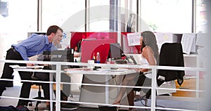 People Working At Desks In Modern Open Plan Office