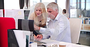 People Working At Desks In Modern Open Plan Office