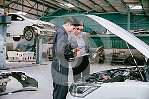 People working estimate repair cost in auto shop. Garage business owner car insurance claim team for help service fix repair