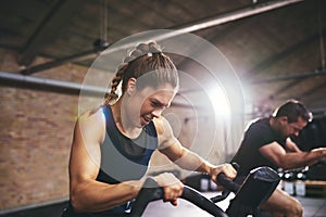 People working exercycle in gym