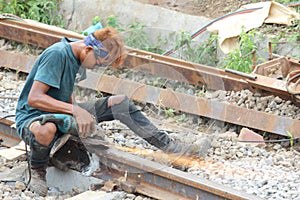 People working grinding train tracks