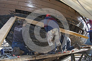 People working on the renovation of a ship
