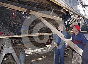 People working on the renovation of a ship