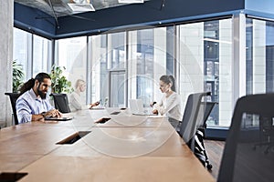 People working while sitting at the office desk together