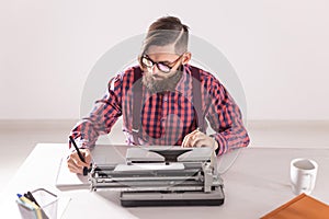 People, world day of writer and hipster concept - young stylish journalist working on typewriter