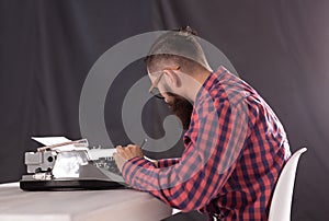 People, writer and hipster concept - young stylish writer working on typewriter