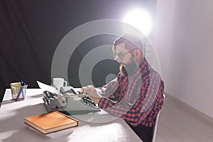 People, writer and hipster concept - young stylish writer working on typewriter