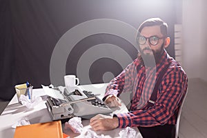 People, writer and hipster concept - young stylish writer working on typewriter