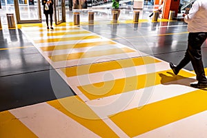 People at the zebra crossing underground Parking. Parking garage underground interior, pedestrian crossing, neon lights